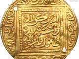 a close up of a gold coin with arabic writing on it