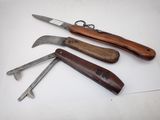 four different types of knives are lined up on a white surface