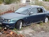 a blue car that is sitting in the grass