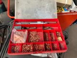 a red tool box filled with assorted screws and nuts