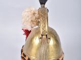 a gold helmet with a fur on top of it