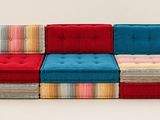 several different colored cushions are stacked on top of each other