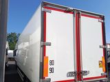 a truck that is parked in a lot with other trucks