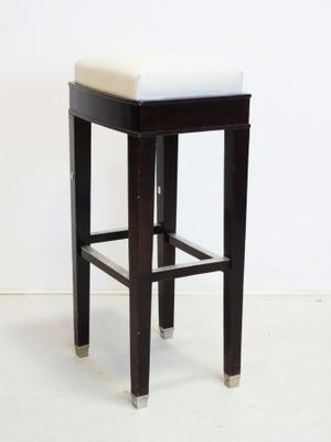 an image of a black and white stool with a white cushion