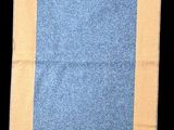 a blue and yellow rug on a black background