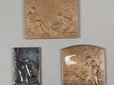 three plaques on the wall of a room