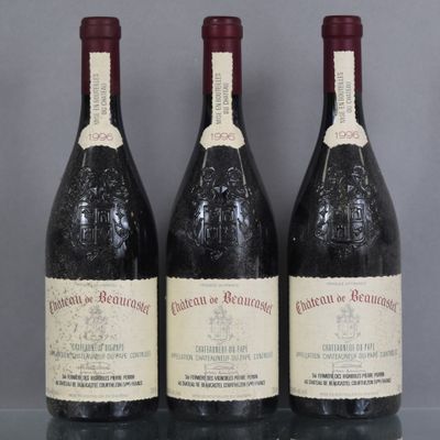 three bottles of wine are lined up on a glass table