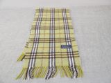 a close up of a yellow plaid scarf on a white surface