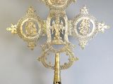 a gold cross that is sitting on a table