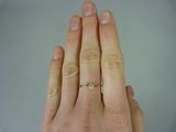a woman ' s hand with a diamond ring on it