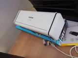 a white printer sitting on top of a desk next to a box
