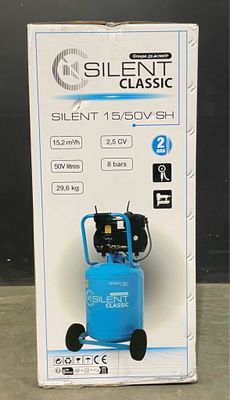 an image of a blue air compressor sitting on top of a cardboard box
