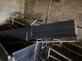 many beds that are in a room with metal rails
