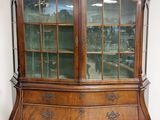 an antique wooden china cabinet with glass doors and drawers