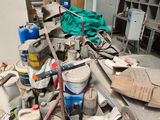 a pile of assorted items sitting on the floor in a garage
