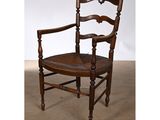 an image of a wooden chair with a brown leather seat