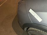 a sticker on the hood of a car that is parked in a garage