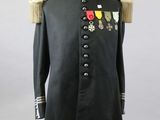 a black military coat with medals on a mannequin stand