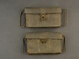 two pieces of leather are sitting on a gray surface