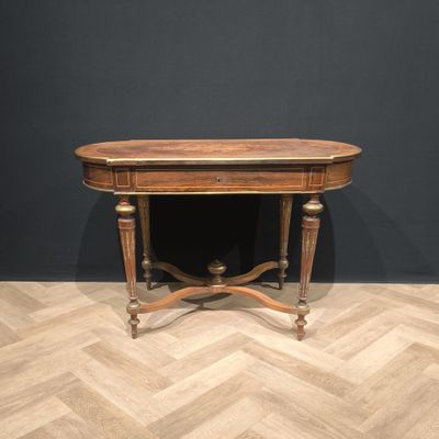 a wooden table sitting on top of a wooden floor next to a black wall
