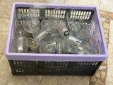 a purple box filled with empty wine glasses on a tiled floor