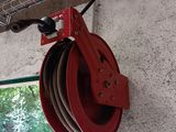 a red pulley attached to the side of a building