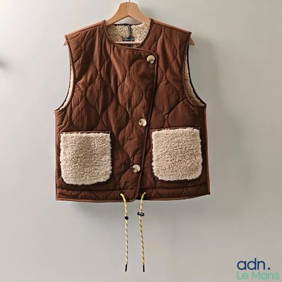 the vest is brown and has two pockets on the front