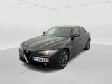 the black alfa coupe is parked in a white room