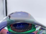 a glass object with a label on it sitting on a table