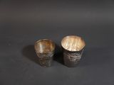 two cups that are sitting on a table