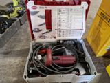 une boîte à outils contenant des outils, posée sur le sol