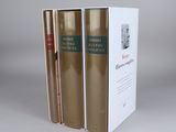 three books are stacked on top of each other on a table