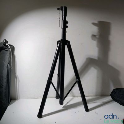 a camera on a tripod next to a bag