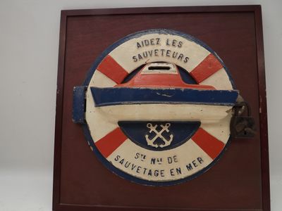 a wooden plaque with a red, white, and blue design on it