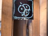 a clock that is on the side of a wooden wall