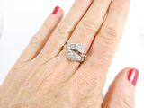 a woman ' s hand with a diamond ring on it