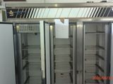 two refrigerators that are open in a room