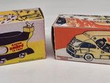 two boxes of toy cars sitting next to each other on a table