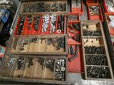 many different types of screws and nuts in a drawer