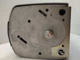 a metal clock that is sitting on a table