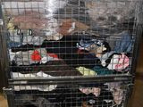 a metal cart with a bunch of clothes in it