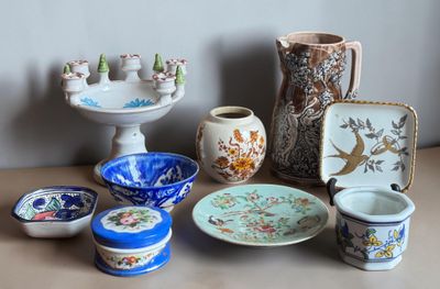 many different types of pottery sitting on a table