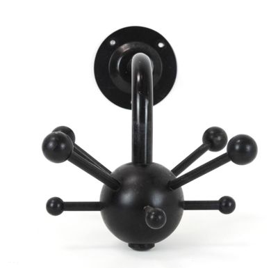 a black object that looks like a spider on a white background