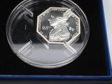 a close up of a coin in a blue box on a table