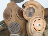 two gas masks sitting next to each other on a table