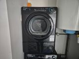 an image of a washer and dryer in a small room