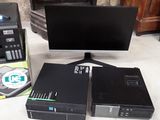 a computer sitting on a table next to a printer and a monitor
