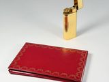 a lighter that is next to a book on a table