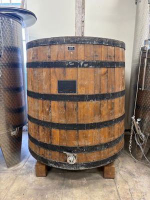 a large wooden barrel sitting in the middle of a room