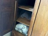 an image of a closet in a bedroom with a bed and a radiator